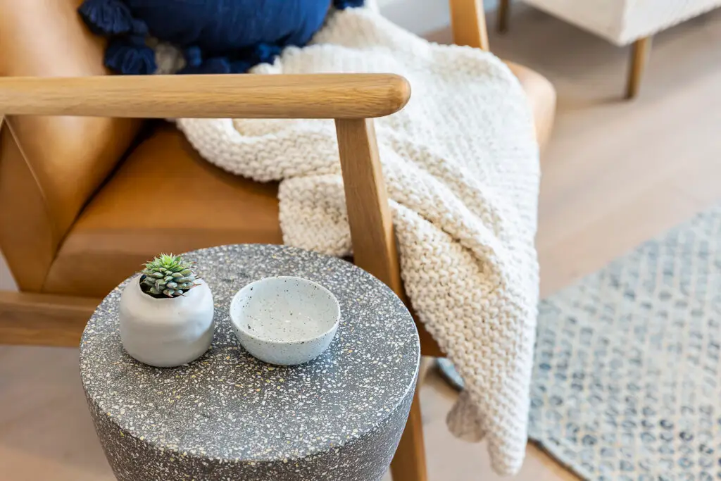 Folded blanket and succulent arranged in a calm interior